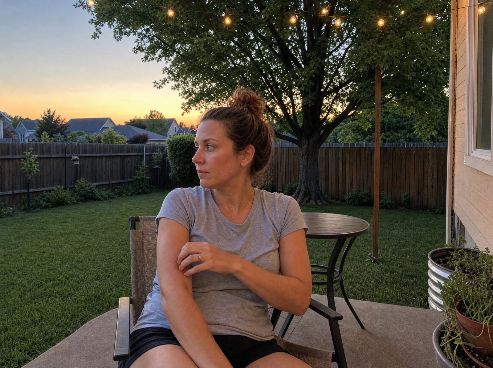 Me on the patio at dusk, swatting at a mosquito.